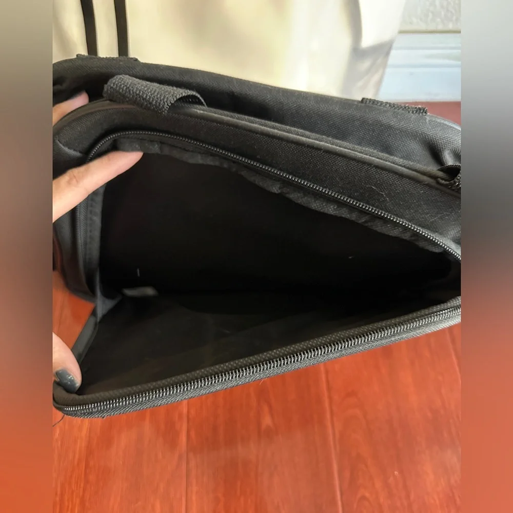 Men’s minimalist black carrying bag for travel or everyday use. Airplane logo.